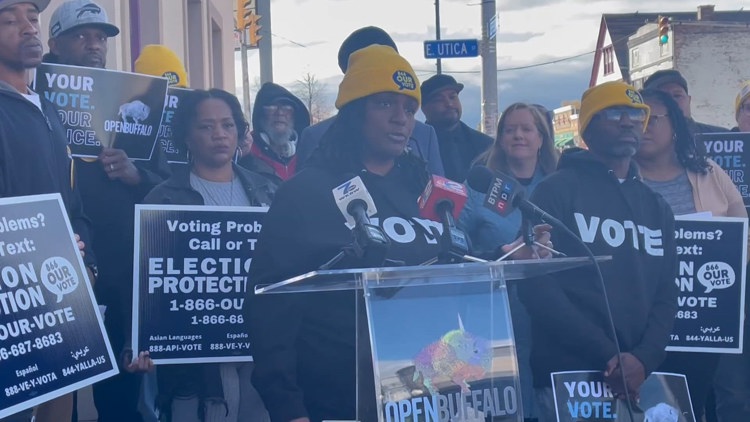 Community advocates wearing yellow hats gather to promote voter rights in Buffalo.